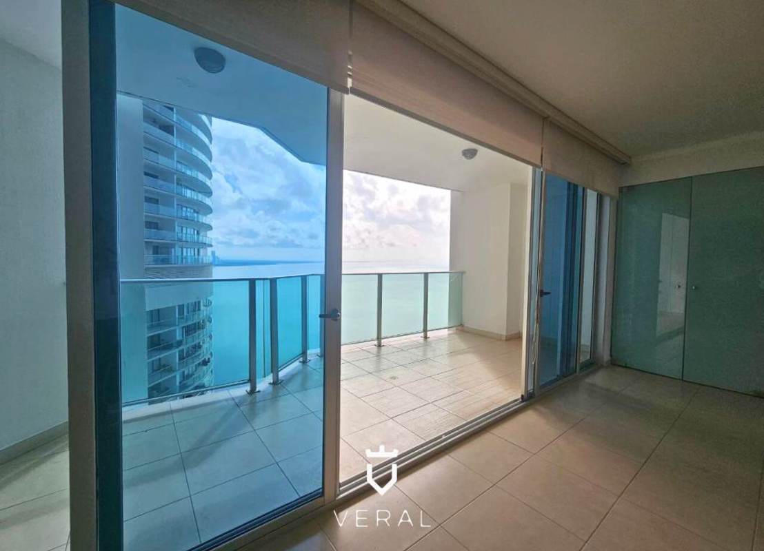Spacious living-dining area with floor-to-ceiling glass and direct ocean view balcony at PH Oasis on the Bay Panama