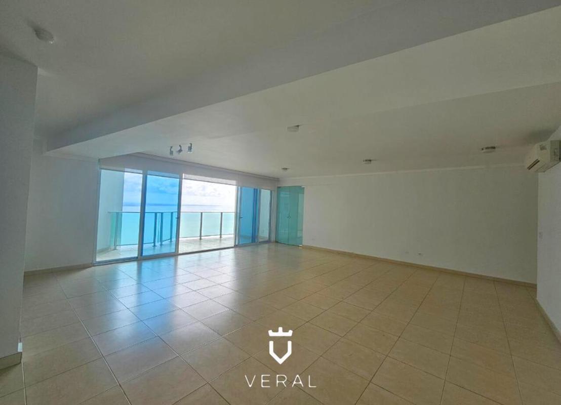 Modern living room with marble floors, AC and floor-to-ceiling glass doors to oceanfront balcony PH Oasis on the Bay Panama