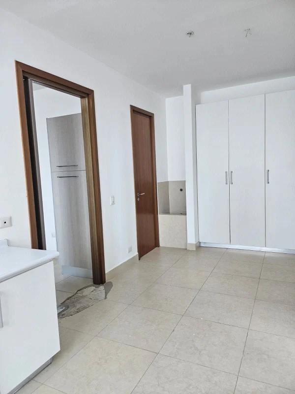 Unfurnished large living room with floor-to-ceiling windows and ocean views in PH Santorini apartment Panama