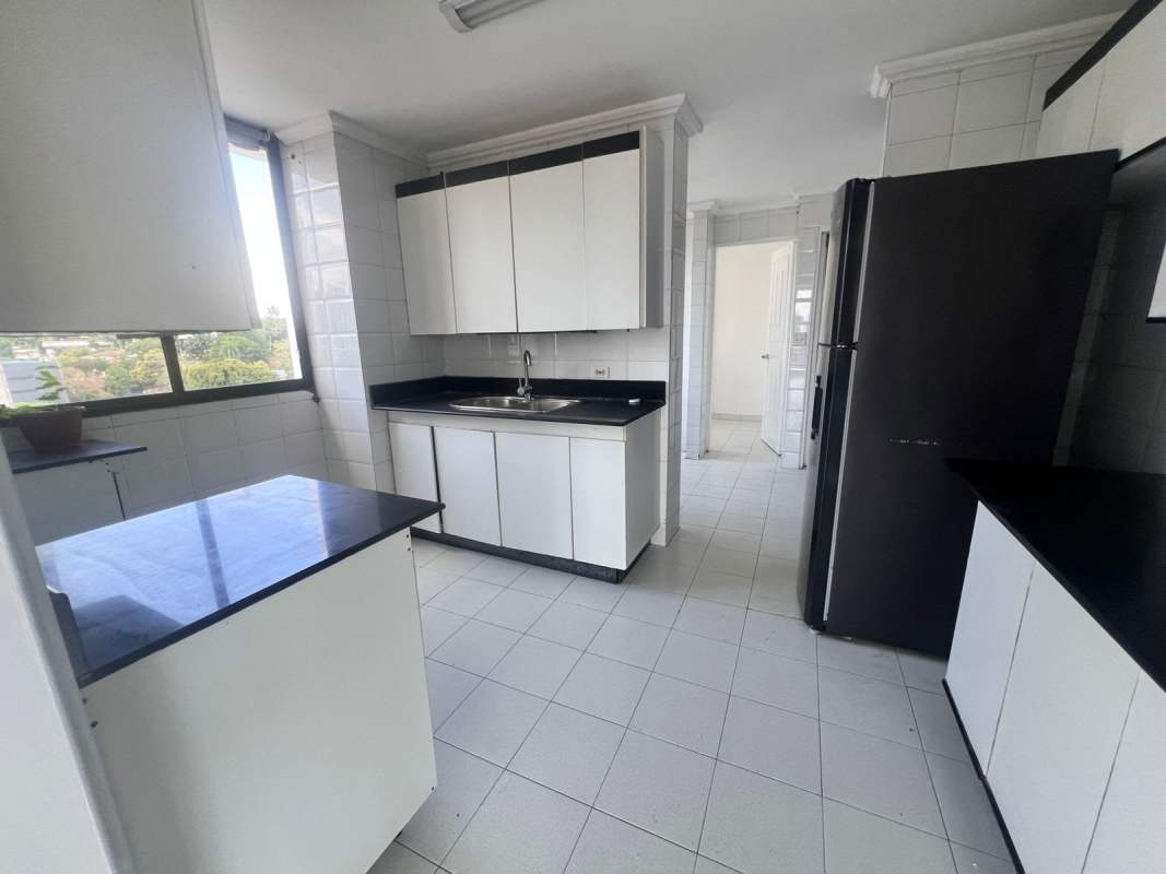Contemporary kitchen with white cabinetry, black countertop in PH Vista Tower Panama