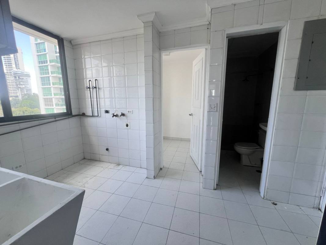 Utility laundry space with service bathroom, window city view in PH Vista Tower Panama