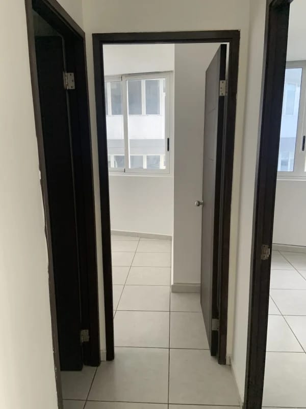 Main bedroom with built-in closet, large window and ocean skyline view at PH Bay View Panama City