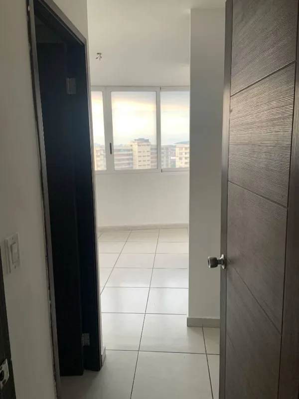 Open kitchen with granite counters and cabinetry in PH Bay View Panama City apartment for sale