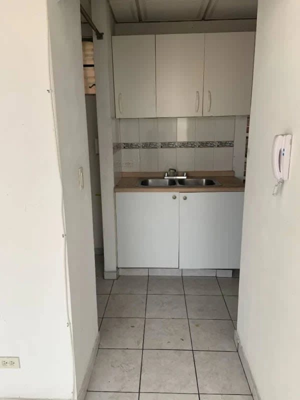 Apartment living room with white tiled flooring and balcony door at PH Torres de Milan Betania Panama