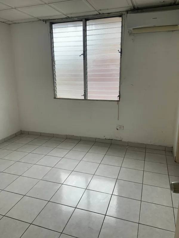 Apartment kitchen with stainless double sink, white cabinets and tile backsplash PH Torres de Milan Panama