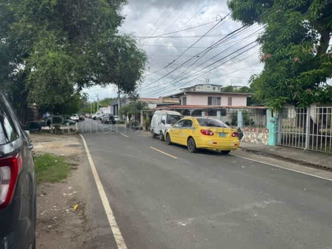 Functional kitchen with green walls, gas stove area, connected dining Rio Abajo Panama