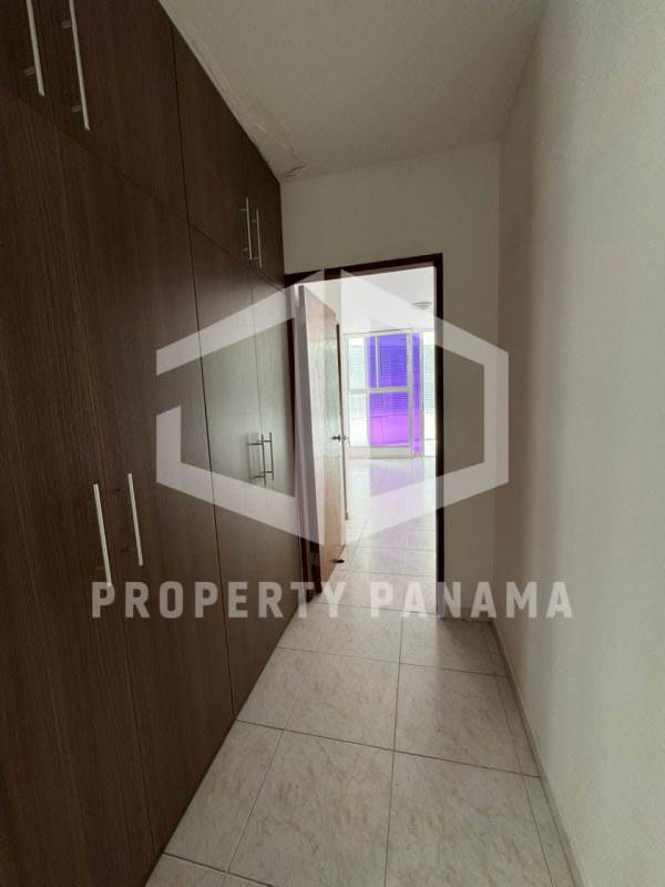 Open plan living dining room empty with tile floors white walls and ceiling lights at PH Deveaux San Francisco Panama