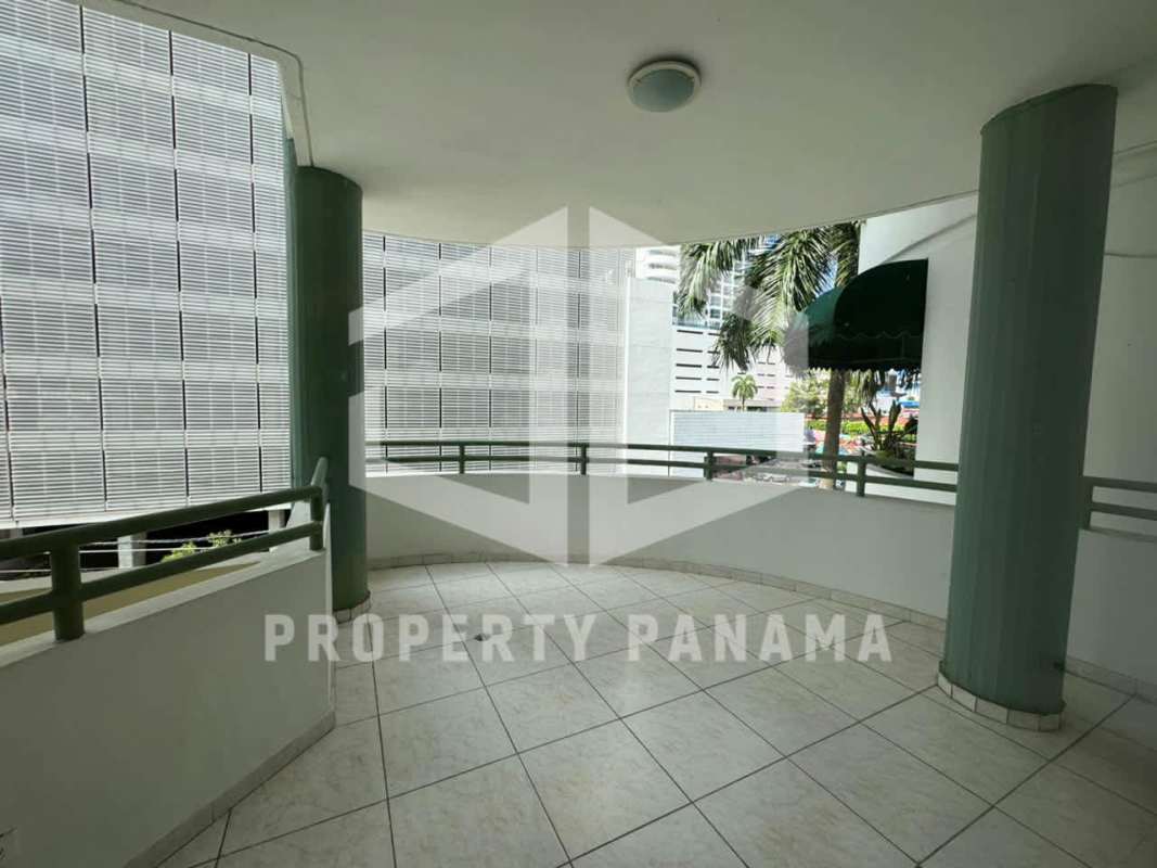 Narrow hallway with dark wood closets tile floor and doorway to bedroom at PH Deveaux San Francisco Panama