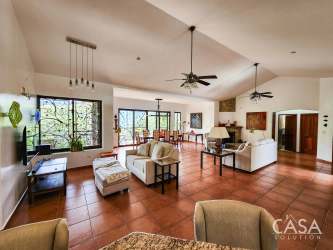 Spacious open-plan living and dining room with high ceilings, tile floor, large windows and scenic garden views in Boquete Panama