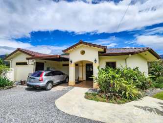 Covered outdoor terrace with seating overlooking lush gardens and panoramic Boquete mountains