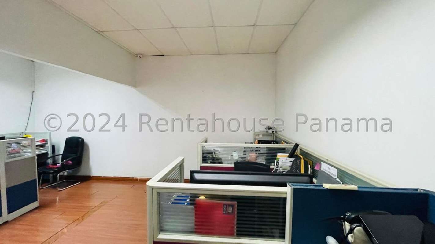Partitioned office cubicles with tile floor and fluorescent lighting inside commercial property Plaza Conquistador Panama
