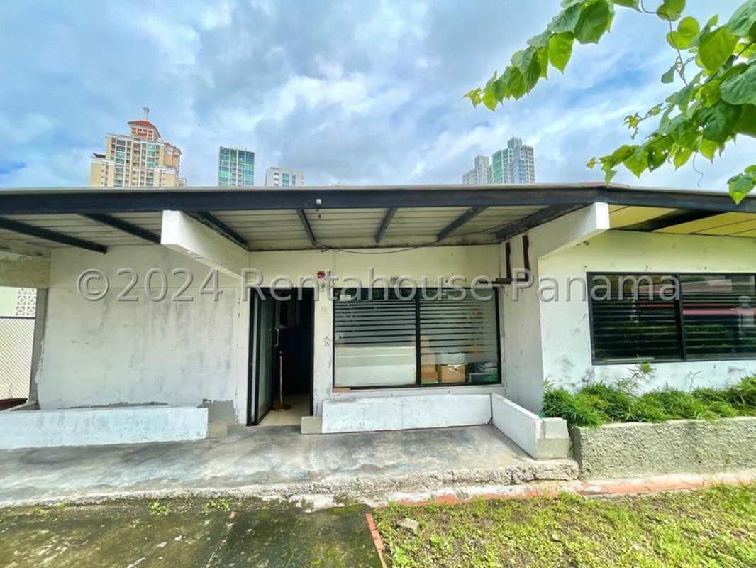 Print shop area with large format printer, office chairs, industrial ceiling, San Francisco Panama