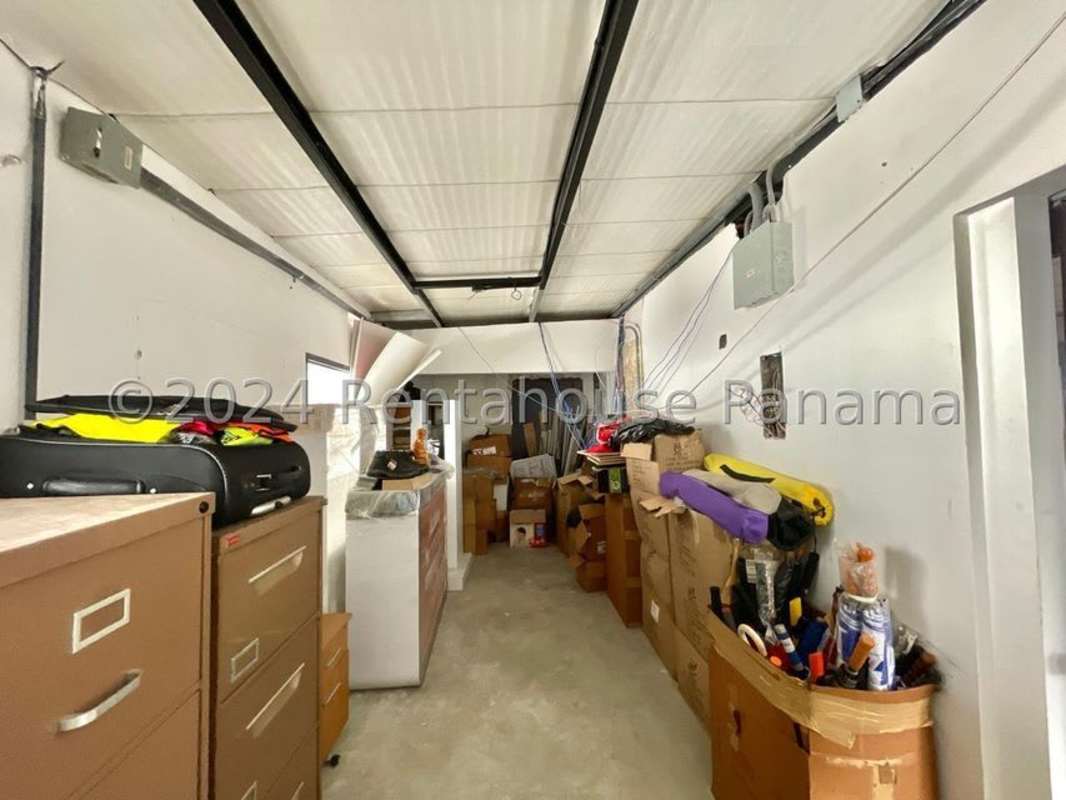 Cluttered storage room with boxes, filing cabinets in low-rise commercial building San Francisco Panama