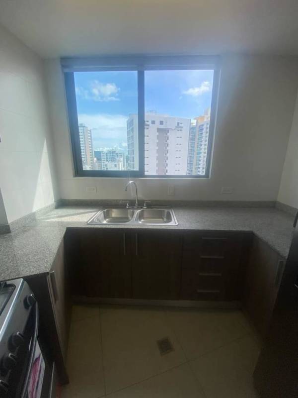 Modern kitchen with granite countertops, large window with Panama City skyline at PH Cranc Tower