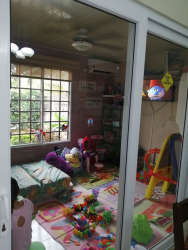 Colorful kids room with wall decals, beds, and fan in family house La Arboleda Panama