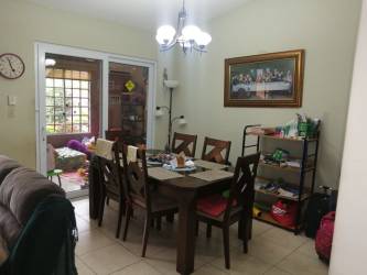 Dining room with chandelier and sliding glass doors to patio family house Costa Verde Panama