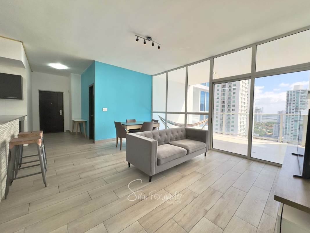 Master bedroom with large windows, en-suite bathroom, panoramic ocean skyline view