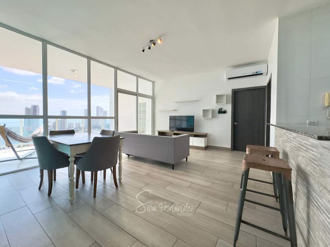 Sleek open kitchen with granite counters, black cabinets, gas stove in PH San Francisco Bay Panama