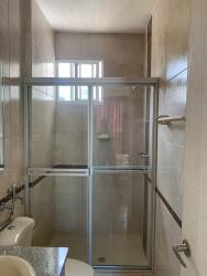 Modern bathroom with glass shower enclosure, granite counter in Playa Dorada Panama condo