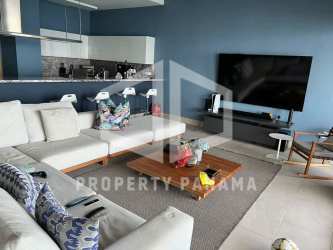 Modern open living room with sectional sofa, large TV, dining space and Caribbean views in PH Playa Escondida Panama