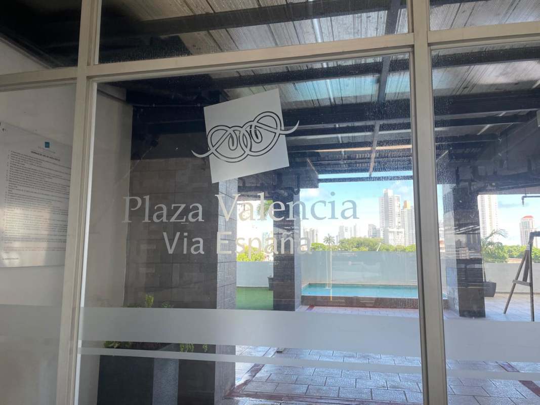 Glass entry signage for PH Plaza Valencia Via España with skyline backdrop Panama