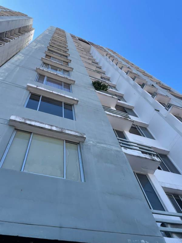 Modern high-rise residential building facade of PH Plaza Valencia, with balconies and city views in Panama City