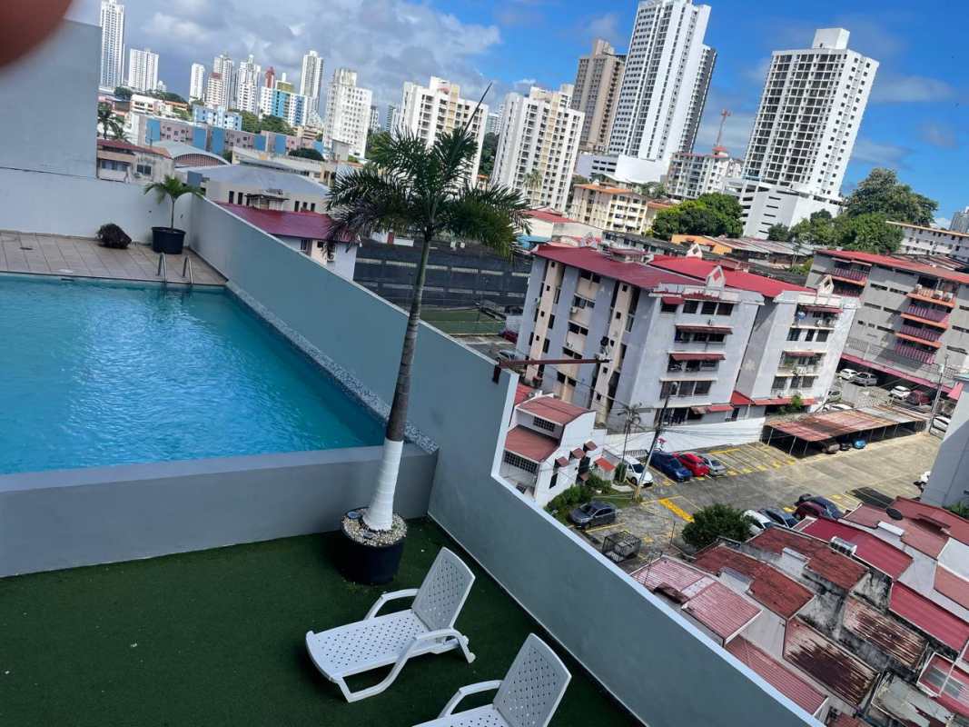 Rooftop swimming pool with sun loungers and city skyline at PH Plaza Valencia Carrasquilla Panama