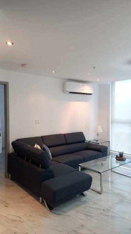 Open kitchen with appliances, dining table and pendant lighting PH The Sands Avenida Balboa