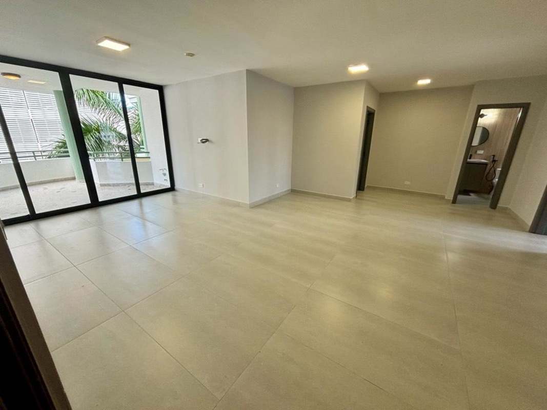 Modern living room with balcony sliding doors overlooking Panama Bay in PH Coco del Mar Panama City