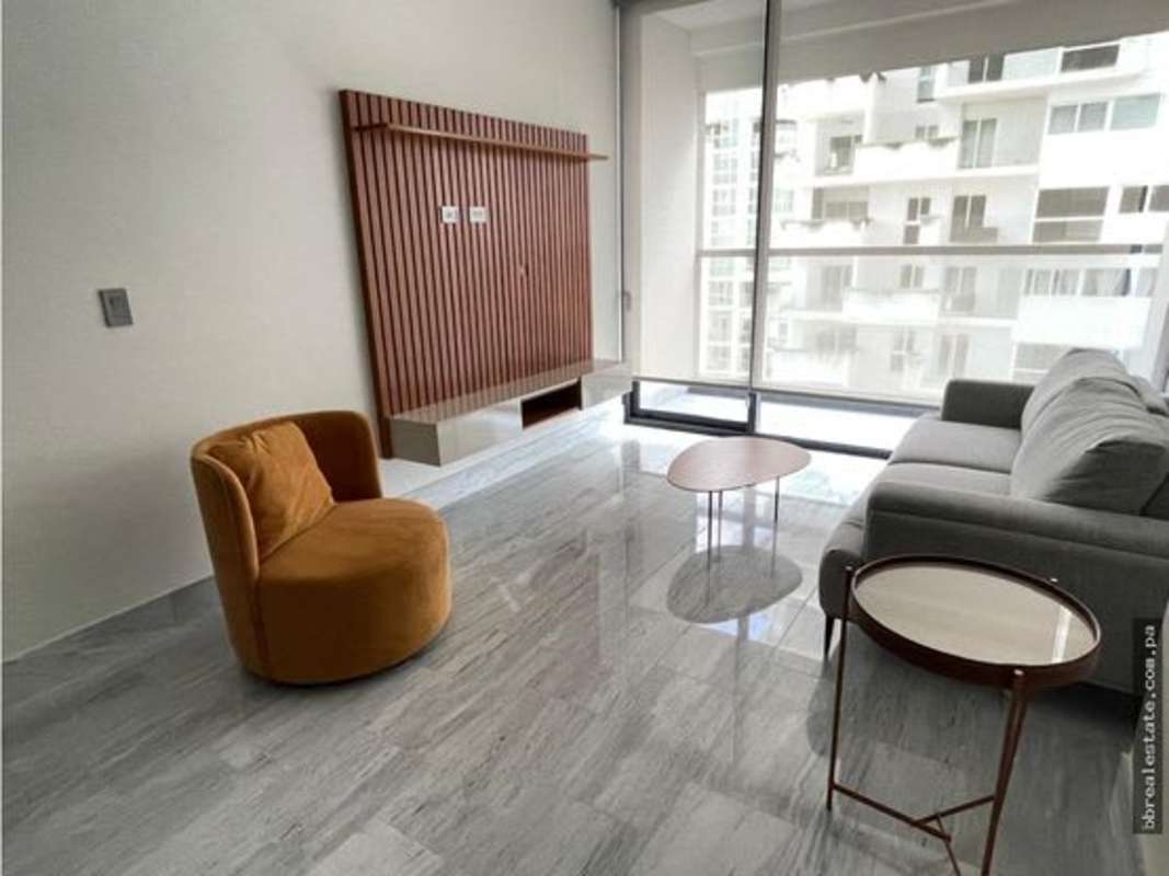 Spacious living room with floor-to-ceiling windows and modern decor in PH Nuovo by Armani Panama City