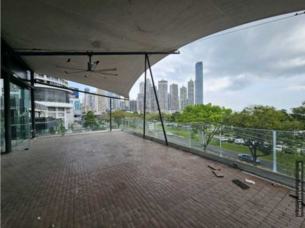 Modern commercial bar area with marble countertop, decorative wall, large window ocean view