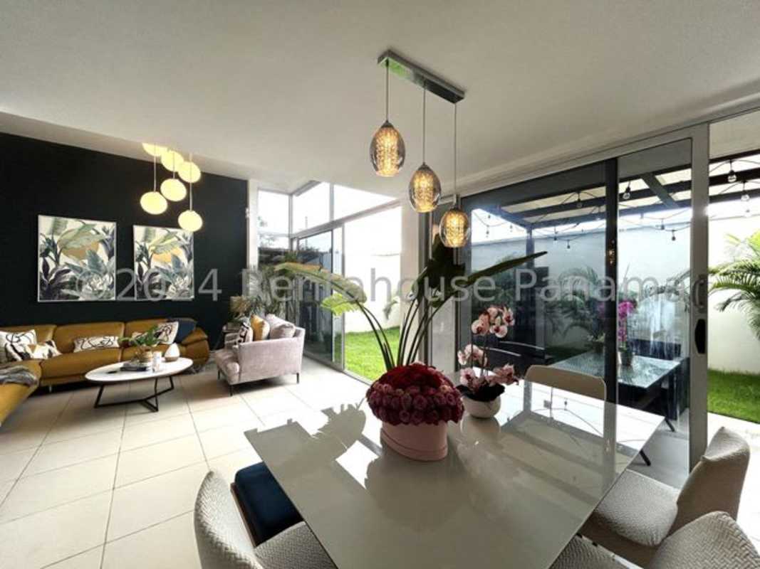 Spacious living dining room with large glass doors opening to patio Costa Sur Panama