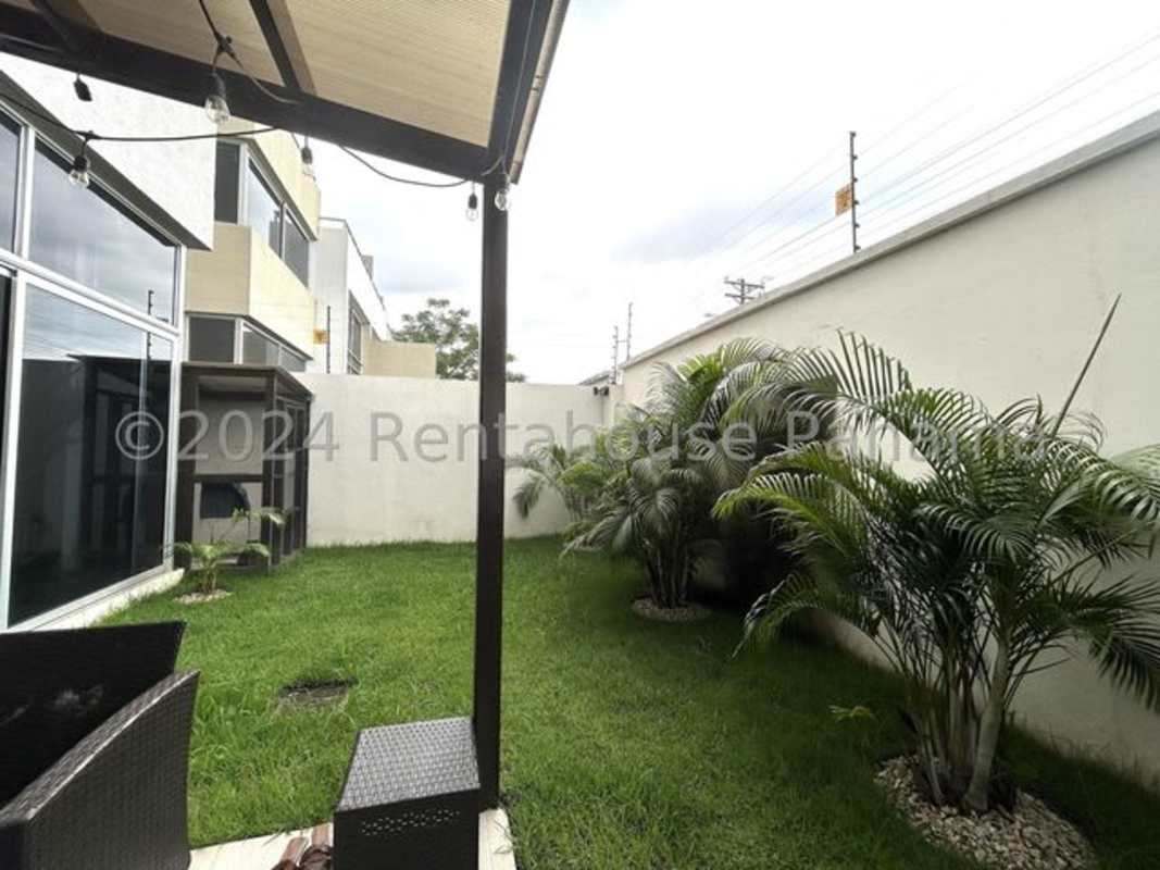 Patio with string lights and landscaped garden in Costa Sur Panama house