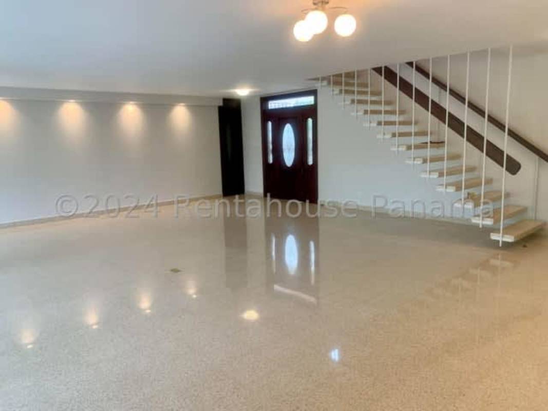 Living room with large windows, polished floors and tray ceiling in Altos del Golf Panama