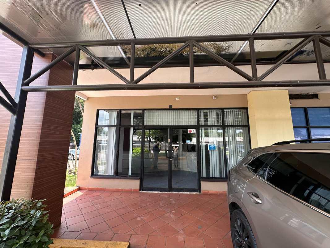 Interior of empty commercial retail unit in Pancanal Plaza with tiled floor and ceiling tiles