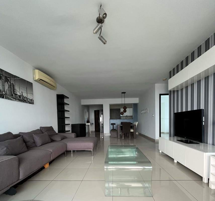 Open-plan living and dining area with floor-to-ceiling windows to balcony at PH Titanium Panama City