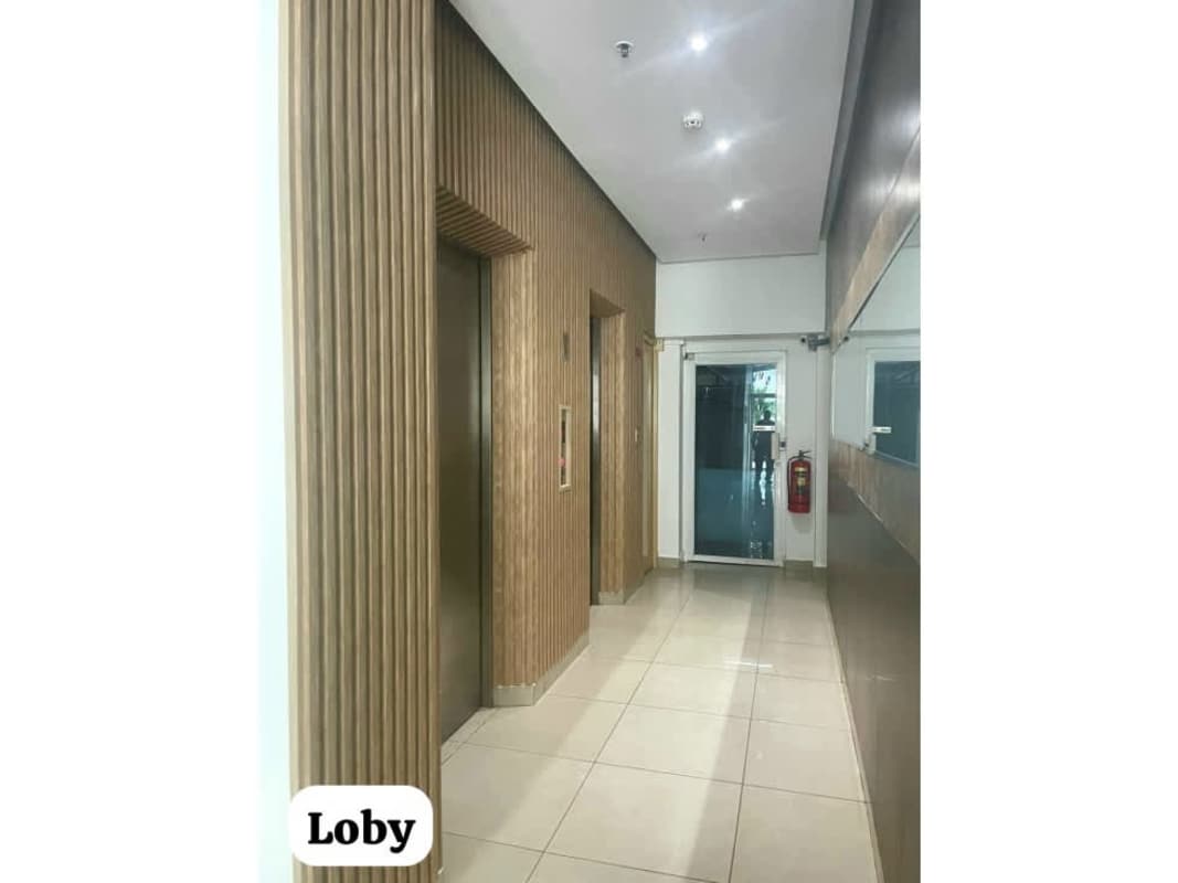 Elegant lobby with wood panels elevator and mirror at PH Crystal Blue Panama City