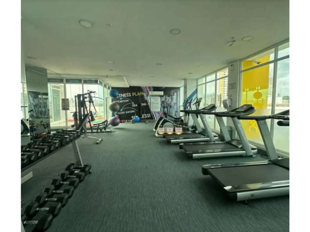 Modern gym with fitness equipment and skyline views PH Metropolitan Park Panama City