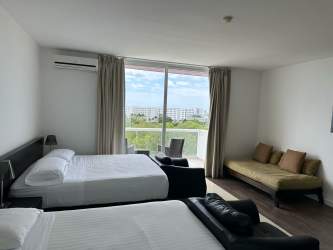 Open studio apartment space with double beds, sofa, balcony Playa Blanca Resort Panama