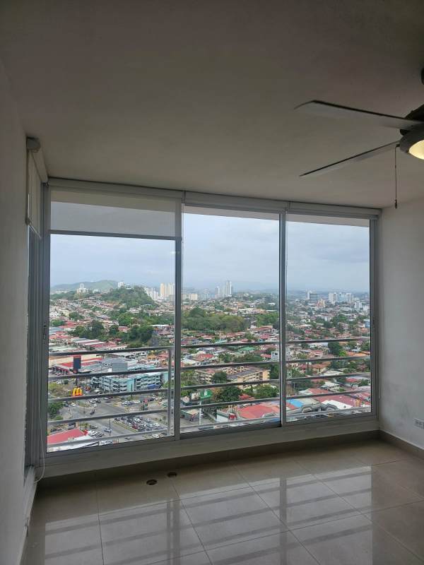 Open plan living room with large windows offering panoramic city view at PH Dos Mares View Panama City