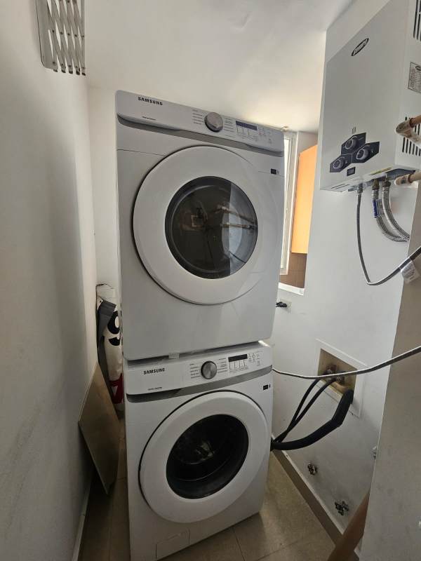 Compact laundry space with hookups for washer dryer in apartment at PH Dos Mares View