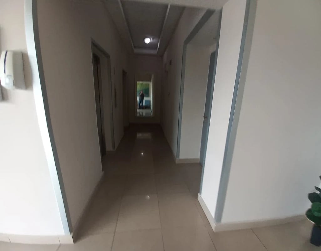 Wide hallway with neutral walls and tile floors in PH Creta Chanis Panama