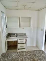 Compact kitchen with upper cabinets, tiled backsplash, stainless steel sink in Quintas del Pacífico La Chorrera Panama