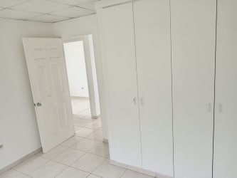 Bedroom featuring built-in closets, tiled floor and white walls in Quintas del Pacífico La Chorrera Panama