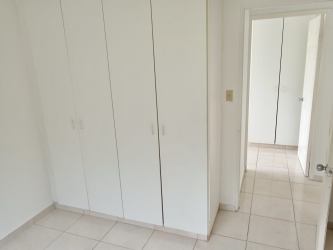 Bedroom with built-in wardrobes, tiled floor and white finish in Quintas del Pacífico La Chorrera Panama