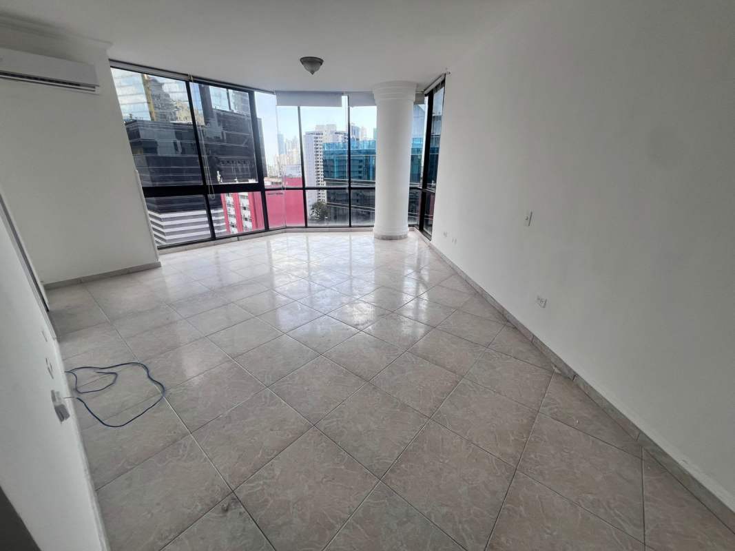 Bright living room with panoramic floor to ceiling windows and marble floors in PH Vista Tower Campo Alegre Panama