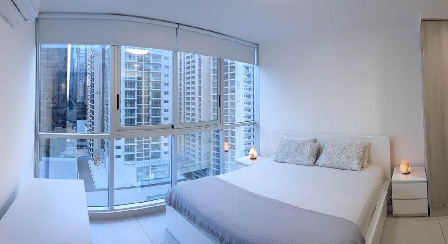 Bedroom with floor-to-ceiling windows panoramic view Obarrio Panama PH Park City rental apartment