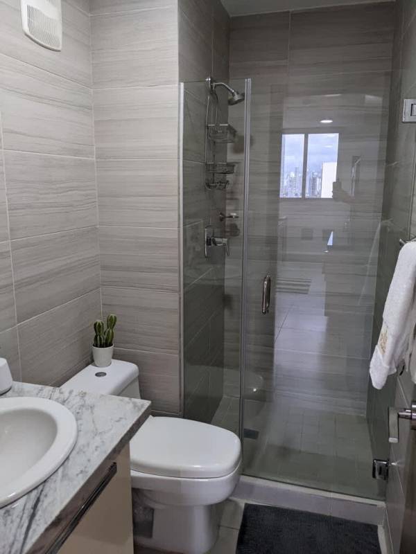 Minimalist bedroom with large wardrobe, AC, tile floors in PH Park City Obarrio Panama rental