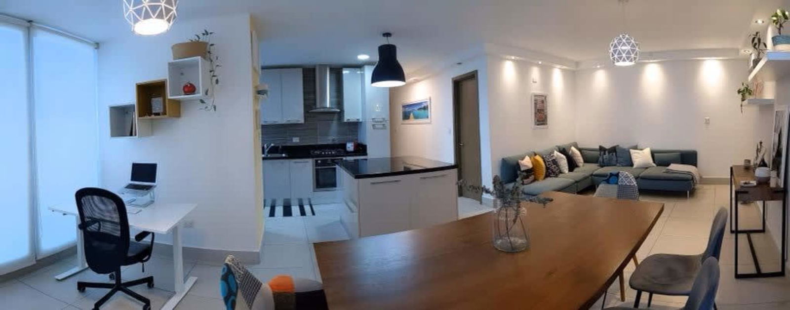 Contemporary kitchen island black countertop stainless steel appliances in PH Park City Obarrio Panama rental apartment