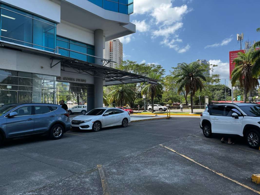 Front of Pacific Salud Tower commercial space with glass facade and parking area in Punta Pacifica Panama